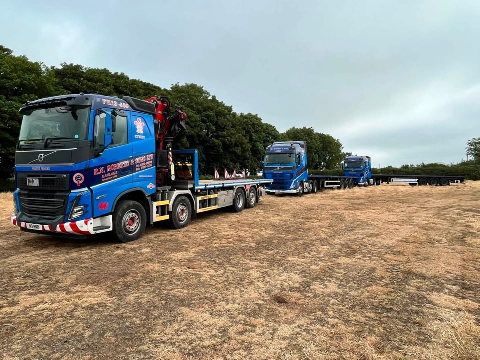 RN Roberts flatbed and HIAB fleet lined up in the field