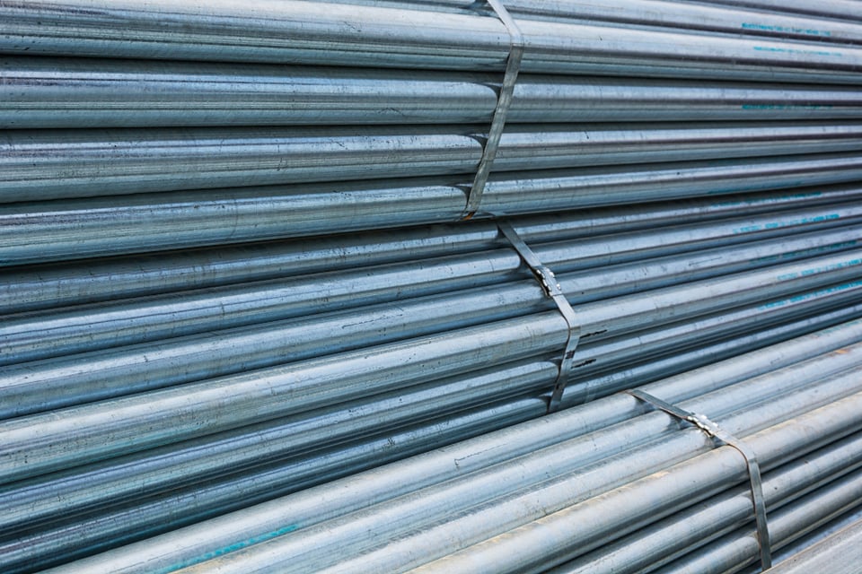 Bundles of galvanised steel tubes, banded and stacked