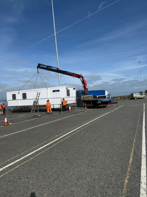 RN Roberts HIAB crane lifting a large modular cabin