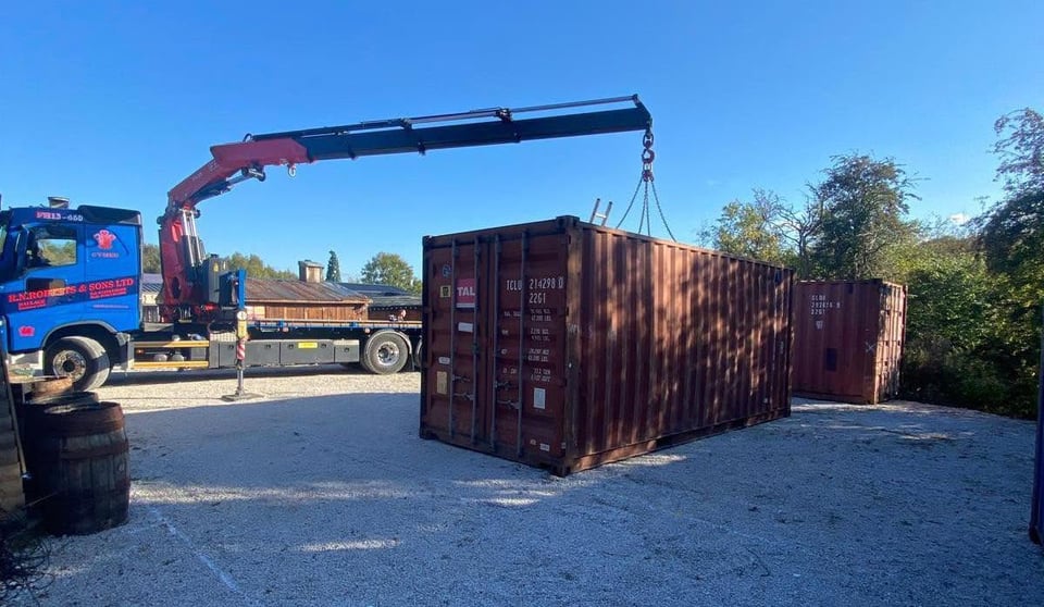 RN Roberts HIAB crane lifting a shipping container