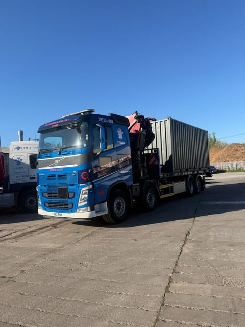 RN Roberts HIAB lorry loading a container in the yard