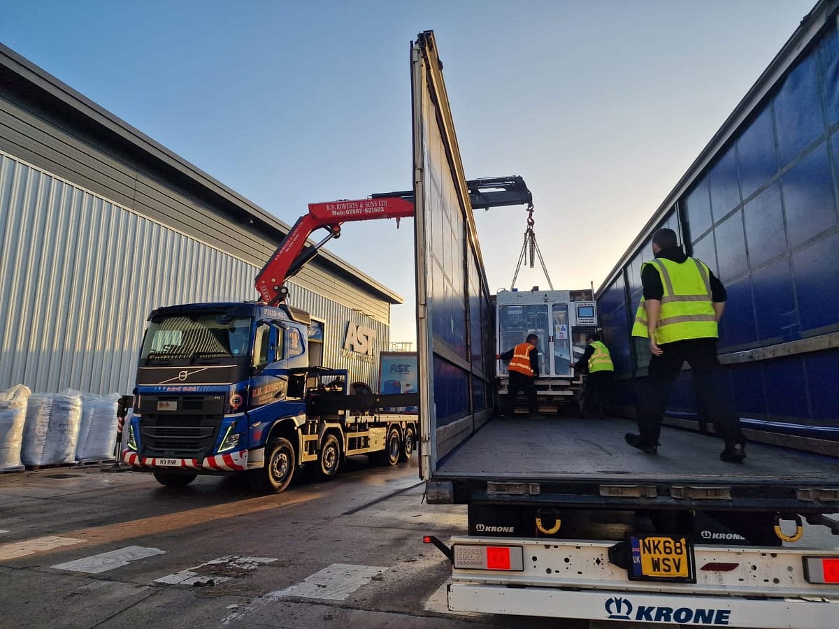 RN Roberts HIAB lorry loading machinery into a curtainsider