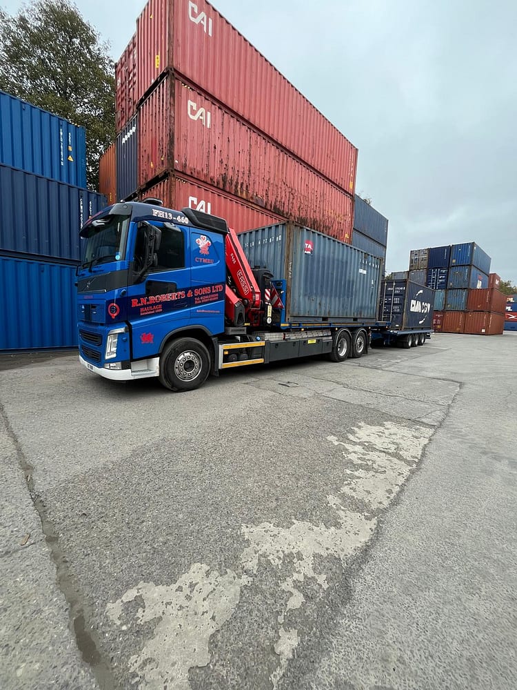 RN Roberts HIAB lorry loaded with a shipping container at a container terminal near Ellesmere Port