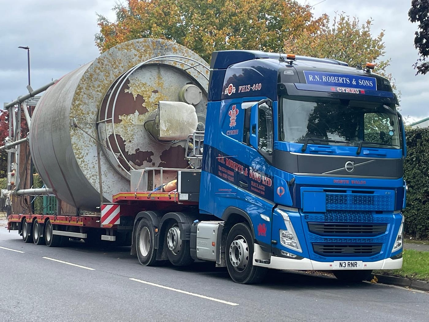 RN Roberts low loader transporting a large industrial silo