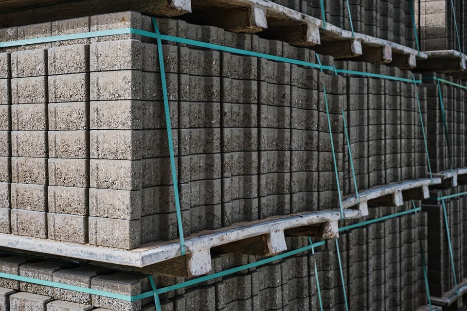 Palletised concrete blocks, strapped and stacked for transport